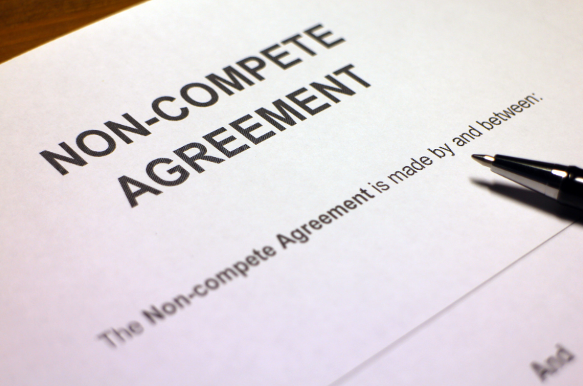 A non-compete agreement document with a pen placed on it, symbolizing the legal process of signing a non-compete agreement in Texas to prevent employees from working for competitors.