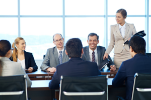 A group of professionals in a meeting, possibly discussing the role and responsibilities of a majority shareholder in a company, including decision-making and influence in corporate matters.