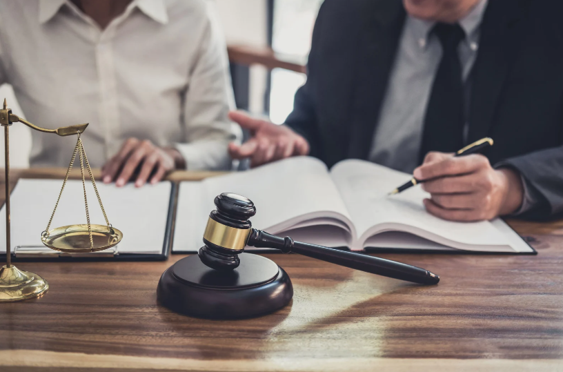 A group of professionals discussing documents, representing a business meeting where parties might be evaluating a business partner agreement or resolving conflicts within the partnership.