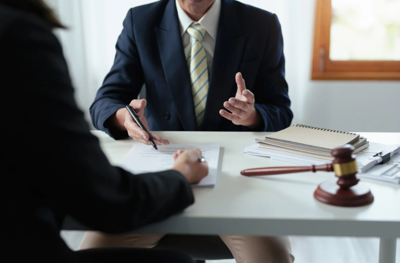 A legal consultation with documents and a gavel, showing a lawyer discussing how to remove a member from an LLC, explaining the steps and implications of member removal within the LLC structure.