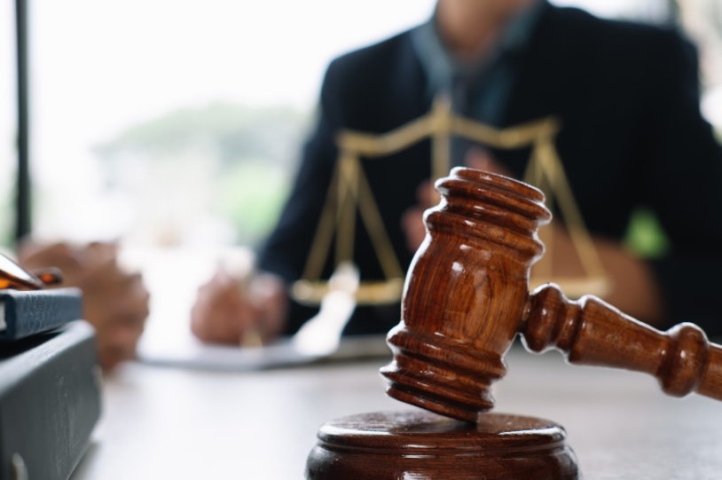 A gavel on a legal desk, illustrating the use of the Texas Long Arm Statute in cases where Texas courts assert jurisdiction over parties outside the state involved in legal disputes.