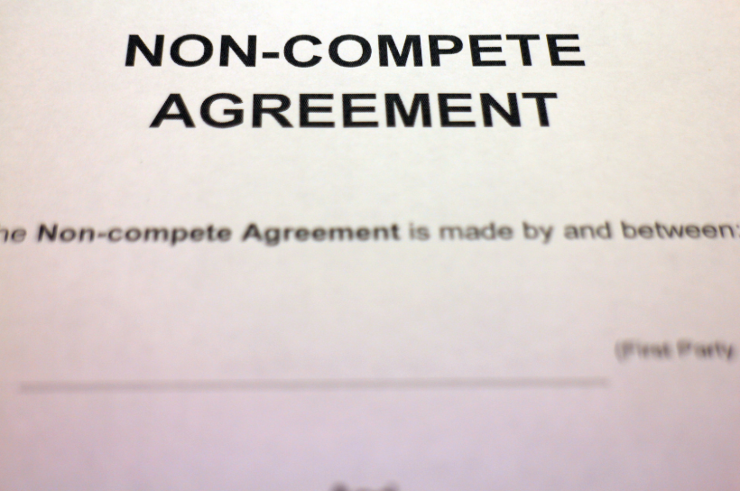 A close-up of a non-compete agreement with the details being filled out. This emphasizes the legal nature of such agreements, where both parties acknowledge and agree on the limitations regarding competition after the contract ends.