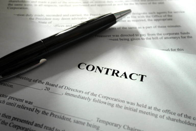 A pen resting on a contract document, symbolizing the signing of agreements under Texas breach of contract law, which governs the legal consequences of broken contracts in Texas.