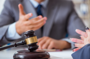 A gavel resting on a table during a discussion, representing the identification of grounds for suing a business partner due to disagreements or breaches of contract.