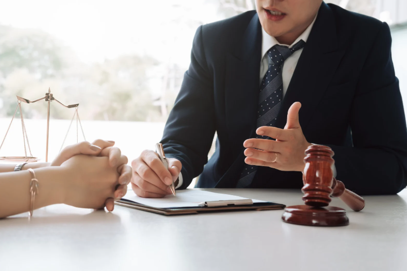 A business litigation lawyer explaining legal matters to a client, discussing potential grounds for suing a business partner based on broken agreements or unfair business practices.