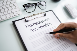 A person reviewing a Homeowners Association (HOA) contract, which could include unenforceable HOA rules in Texas. Such rules might be challenged if they violate state laws or contradict the homeowner's rights.