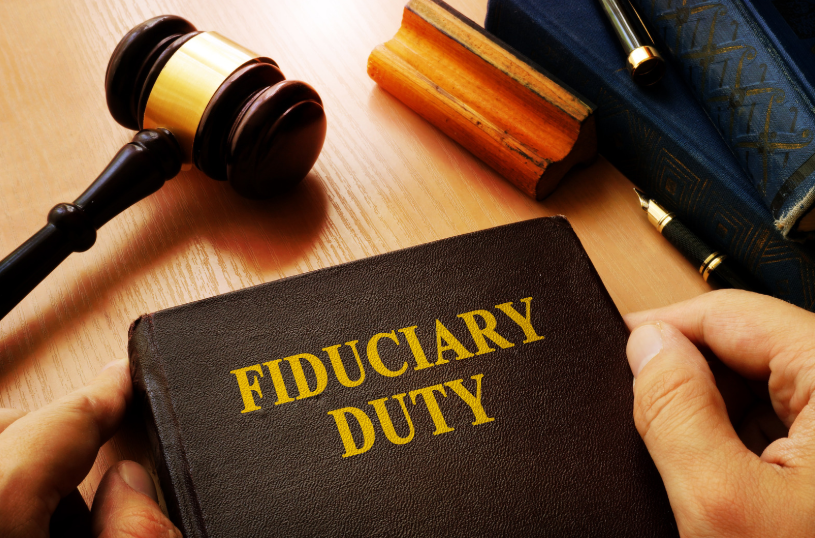 Book titled 'Fiduciary Duty' next to a gavel and legal documents, representing topics related to fiduciary litigation attorney.